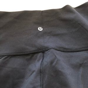Lululemon black yoga pants with mesh insets.